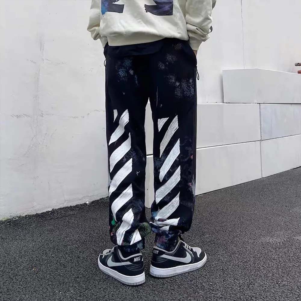 ♻️💯Refer to the model picture for the upper body❤️Examined version OFF 17FW WHITE Starry Sky Fireworks Splash Ink OW Sports Autumn and Winter Sweatpants Casual Pants for Men and Women. The firework color is obtained through contrasting printing. There are eight panels in the whole body. Seven color sets and eight panels are divided into eight printings. The first layer is gray, the second layer is white, the third layer is yellow, the fourth layer is green, the fifth layer is blue, the sixth layer is purple, the seventh layer is orange, and the last layer is arrow paint printing. The seven colors are layered on top of each other, and new colors will appear. The arrows on the back and the squares on the front are first glued and then hung four times in a row. The paint has a distinct concave and convex feeling. Quality depends on the details. The blue letters are electrostatic three-dimensional flocking. They are done separately first and then printed through high-temperature thermal transfer. The difficulty is unprecedentedly high. The total number of fireworks series produced exceeds 50,000 pieces, and more than half of the ones seen on the market are from my home!  Size: XS-L Color: Black (The waist is elastic and can be enlarged) P: 380